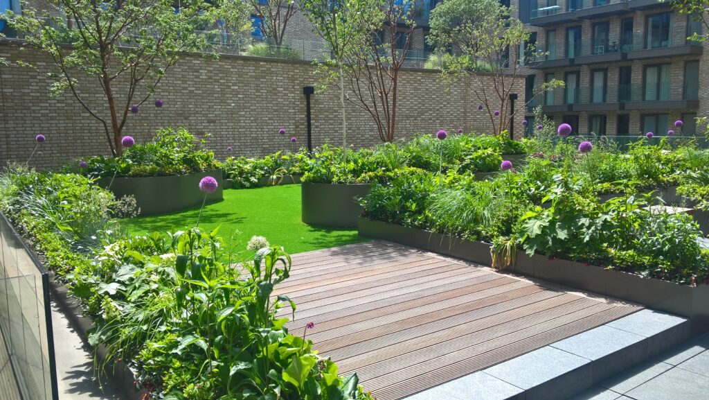 Decking leading onto grass turfing all installed by Greenstone landscapes