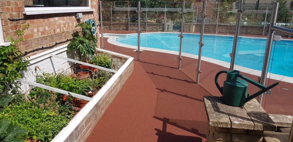 resin surfacing idea showing terracotta resin bound pool surround installed by Greenstone Landscapes in Kent
