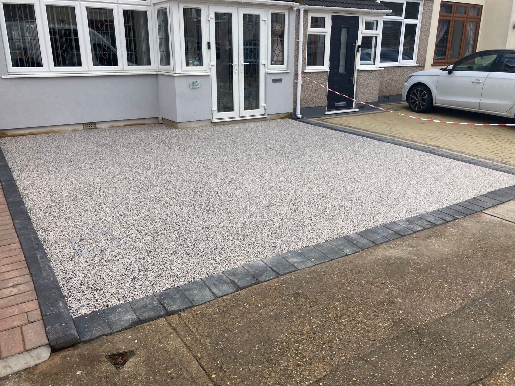 Grey block paving edges on resin driveway in Rainham Kent